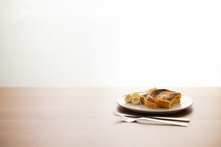 French toast with butter on wood table and white background with copy spaceの写真素材
