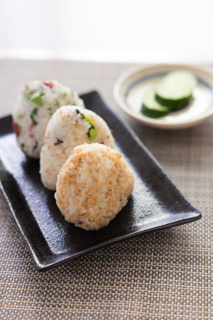 Japanese food, rice ball with seaweed and edamame on white backgroundの写真素材