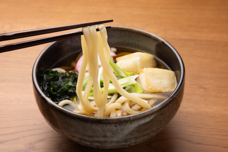 Japanese udon noodle soup with baked rice cakes and green onionの写真素材