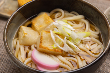 Japanese udon noodle soup with baked rice cakes and green onionの写真素材
