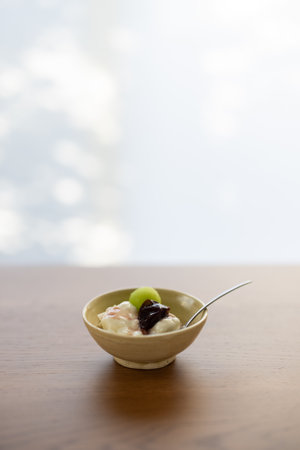 yogurt with grape and jam on wooden tableの写真素材