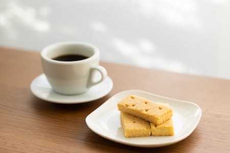 Coffee and cookies on the wooden table in coffee shop.の写真素材
