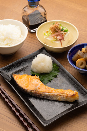 Grilled salmon with rice and soy sauce on wooden table, Japanese foodの写真素材
