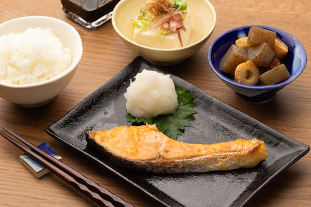 Grilled salmon with rice and soy sauce on wooden table, Japanese foodの写真素材