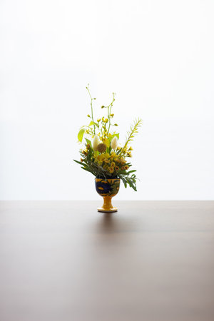 Bouquet of yellow flowers in a vase on the tableの写真素材