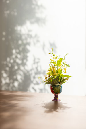 Bouquet of yellow flowers in a vase on the tableの写真素材