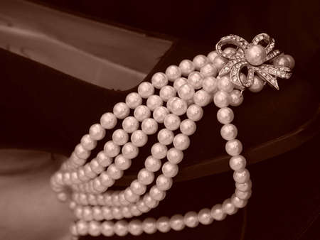 Black pump laden with pearl necklaceの写真素材