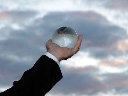 Man holding world globe with his his hand toward the sky.の写真素材