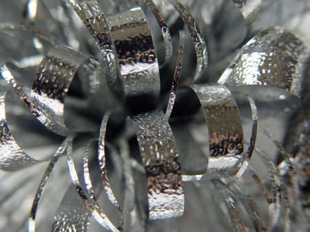 Macro shot of silver bow on a white background.の写真素材