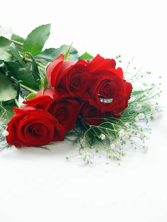 Half dozen red rose with trinity diamond ring in the center of one roseの写真素材