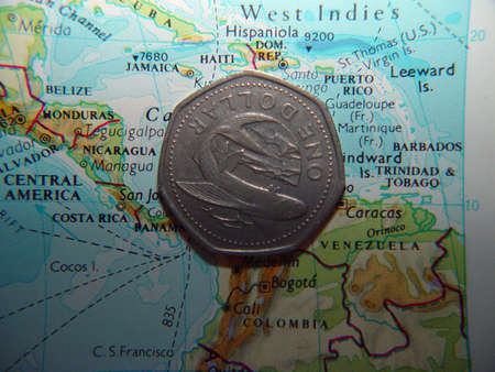 Barbados one dollar coin over map with barbados.の写真素材