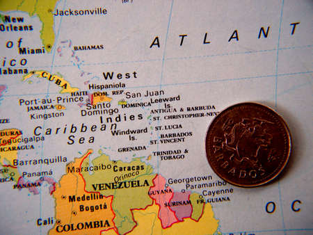 Barbados coin on atlas next to barbadosの写真素材