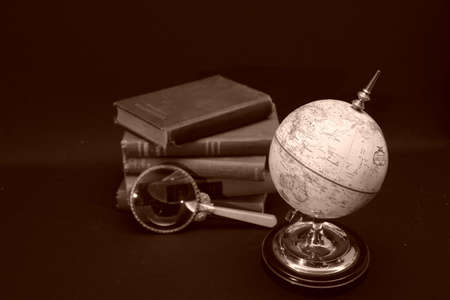 World Globe with various books in background.の写真素材
