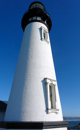 looking up at an old stately lighthouse in oregonの写真素材