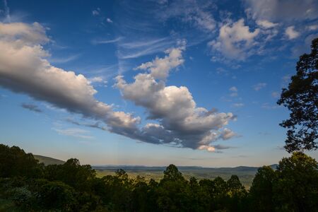 Valley view with puffy clouds and blue Skyの写真素材