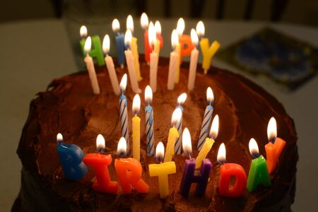 Chocolate birthday cake with Happy Birthday candles. focus on Birthdayの写真素材