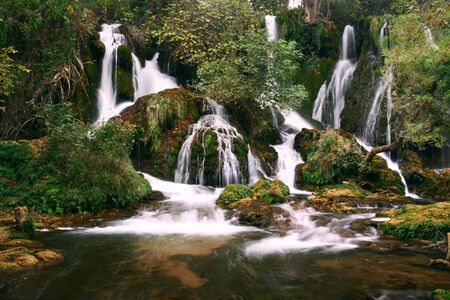 serene waterfall cascades in wildernessの写真素材