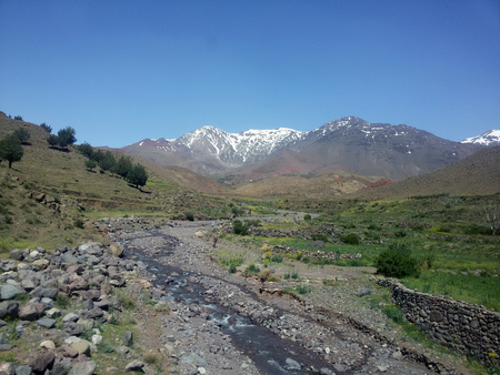 Mountain next to a small almost dried river in Moroccoの写真素材
