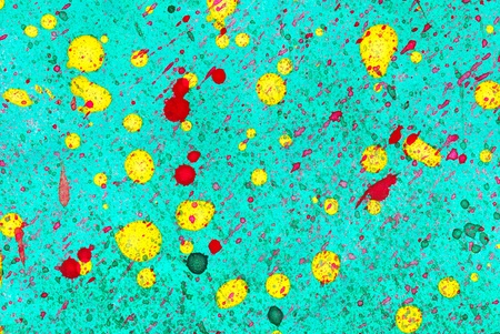 yellow and red watercolor droplets on green