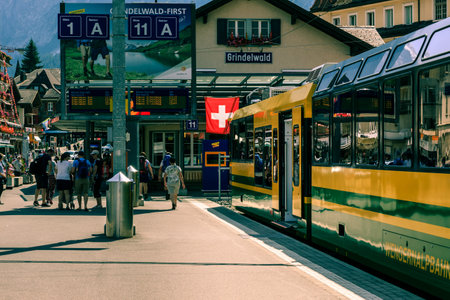 Grindelwald, Bernese Oberland, Switzerland - AUGUST 1, 2017 : Yellow - Green train from the Wengernalpbahn in the Grindelwald railway stationのeditorial素材