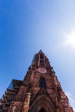 low angle view of the Freiburg Munster on a sunny day under clear blue sky. Freiburg im Breisgau, Baden-Wurttemberg, Black Forest south west Germanyの写真素材