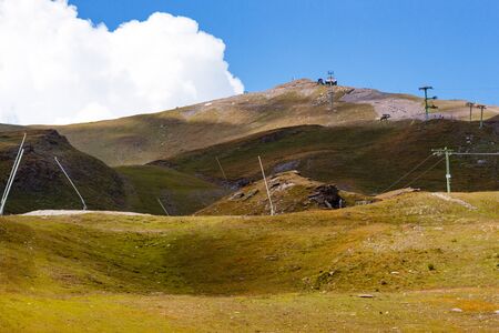 Slopes with green pastures and unused ski lifts in the summer, Pennine Alps, Val d' Anniviers, canton of Valais, Switzerlandの写真素材