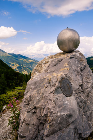 Saint-Luc, Valais, Switzerland - August 8 2018: Planet Uranus statue high up in the Pennine Alps on the Planets Trail on a sunny day in the summerのeditorial素材