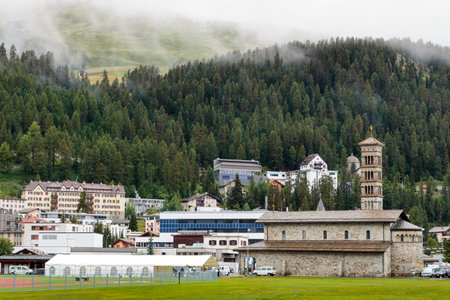 St. Moritz, Engadin, Graubunden, Switzeland - August 5 2016 : view on St. Moritz Bad with the St Charles church on the foreground on a foggy summer dayのeditorial素材