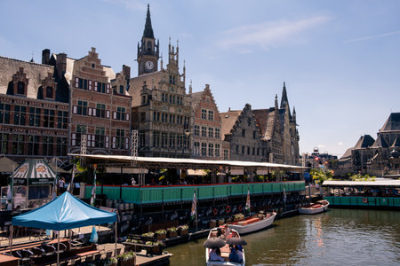Ghent, Flanders, Belgium - July 15 2018 : view on the Graslei with the Leie river and some tourists...