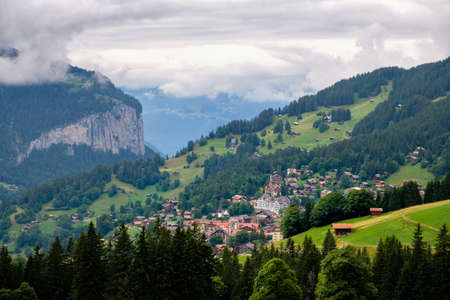High angle view on picturesque car free mountain village Wengen in the Bernese Alps on a cloudy day in summer. Wengen, Bernese Oberland, Switzerlandの写真素材