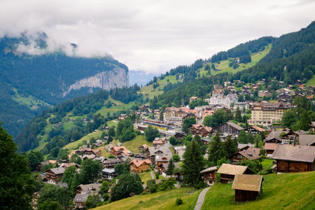 Wengen, Bernese Oberland, Switzerland - July 29 2019: view on picturesque car free mountain village Wengen in the Bernese Alps on a cloudy day in summerのeditorial素材