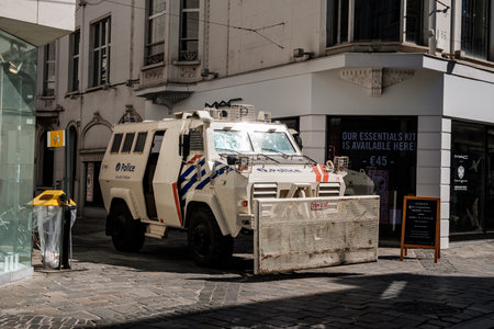 Ghent, Flanders, Belgium - July 15 2018: white armored riot truck with front clearing blade of Belgian police parked on the corner of a street downtown during the Ghent Festivities (Gentse Feesten)のeditorial素材