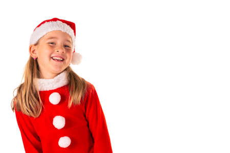 Portrait of beautiful cheerful 8 year old girl smiling and wearing red christmas costume with red...