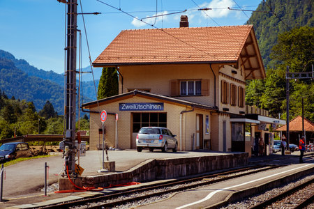 ZweilÃ¼tschinen, Bernese Oberland, Switzerland - August 4 2019: Railway station building and passengers on the platform on a sunny day in summerのeditorial素材