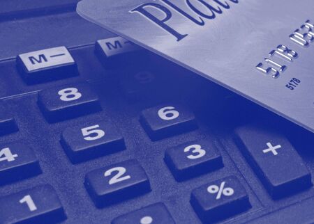 credit card laying on top of a calculatorの写真素材