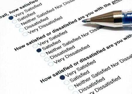 Customer satisfaction survey with pen on the side