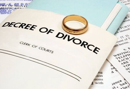 Divorce decree and wedding ring symbolizing the end of a marriageの写真素材