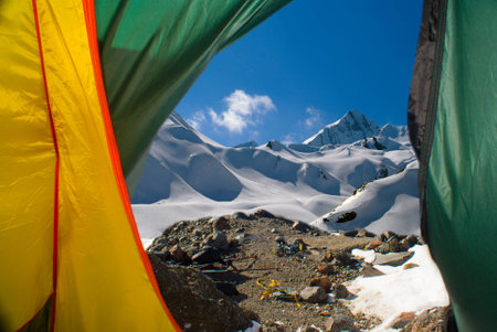 Beautiful mountain landscape is visible in opening of tent thrown by openの写真素材