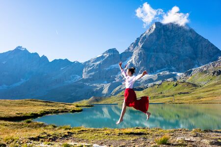 Young girl dancing in the mountainsの写真素材