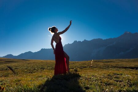Young girl dancing in the mountainsの写真素材
