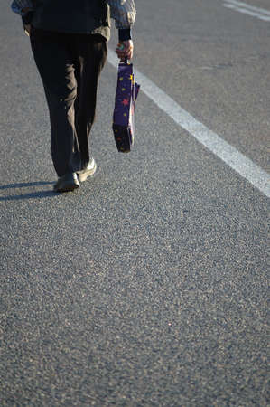 men on the road with dark shadowsの写真素材