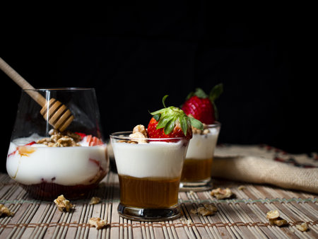 Natural and healthy dessert of yogurt, honey, strawberries and walnutsの写真素材