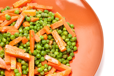 cooked peas and carrots into piecesの写真素材
