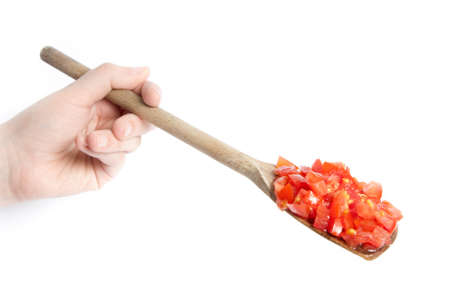 Sliced tomatoes on wooden spoonの写真素材