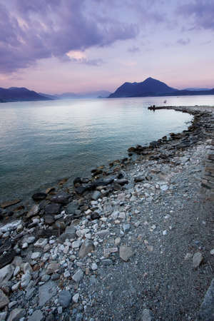 View of Lake Maggiore from the shore at sunset, a famous tourist Italianの写真素材