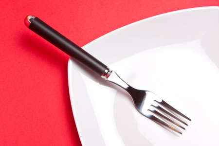 Fork resting on a plateの写真素材