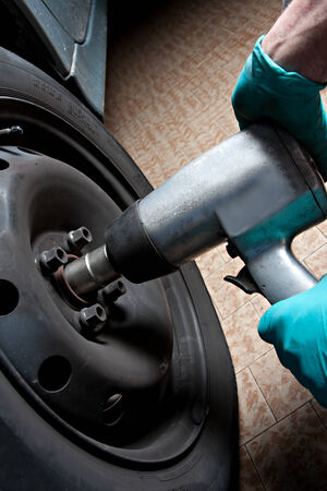 mechanic fixing a car wheelの写真素材