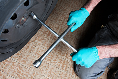 mechanic fixing a car wheelの写真素材