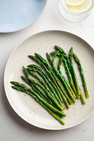 Grilled green asparagus on a a plate, top view.の写真素材