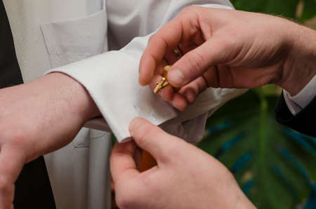 Wedding groom fees for weddings, help each other when dressingの写真素材